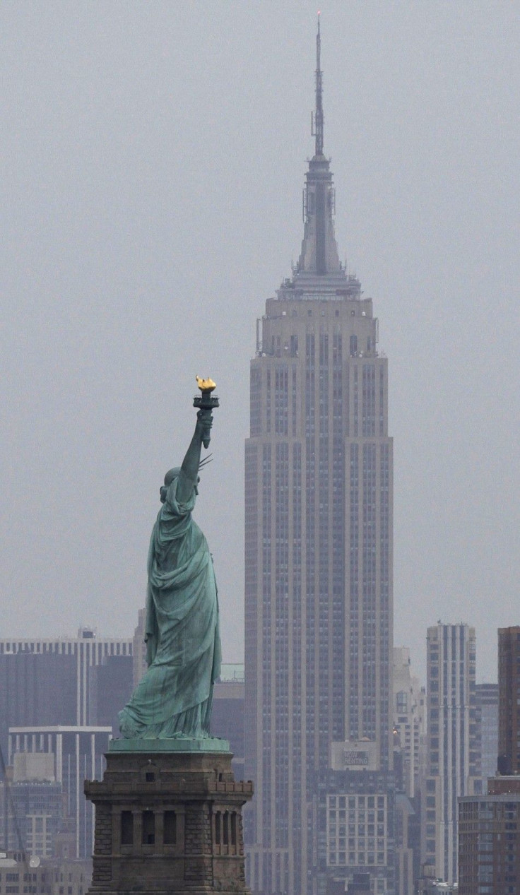 The Statue of Liberty sits next to the Empire State Building as seen from Bayonne