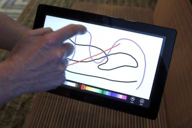 A Reuters reporter runs through a new test Microsoft Windows tablet running a version of its touch-enabled Windows 8