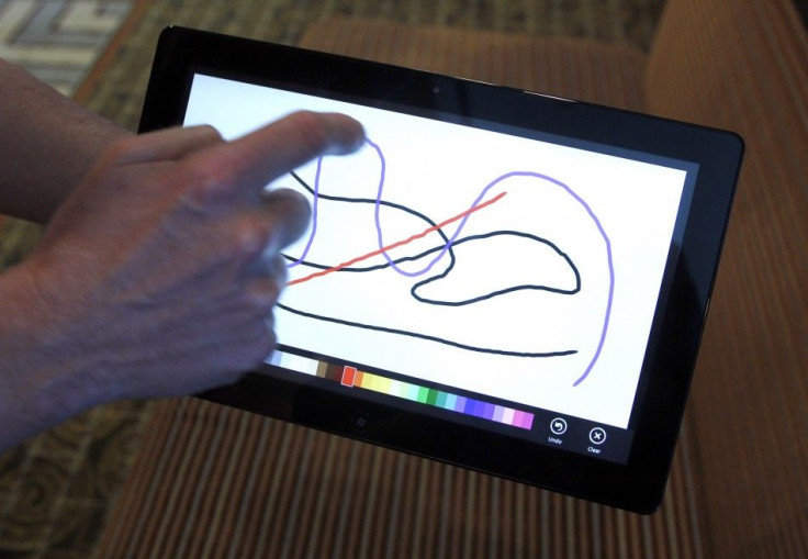 A Reuters reporter runs through a new test Microsoft Windows tablet running a version of its touch-enabled Windows 8