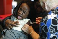 A single shot vaccination will provide protection against all kinds of flu viruses for life including bird flu and swine flu.  Here Fofu, 4, screams while her mother Abena holds her as a nurse injects a shot of the H1N1 flu vaccine, in Arlington, Texas No