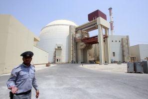 A security official talks to journalists in front of Bushehr main nuclear reactor