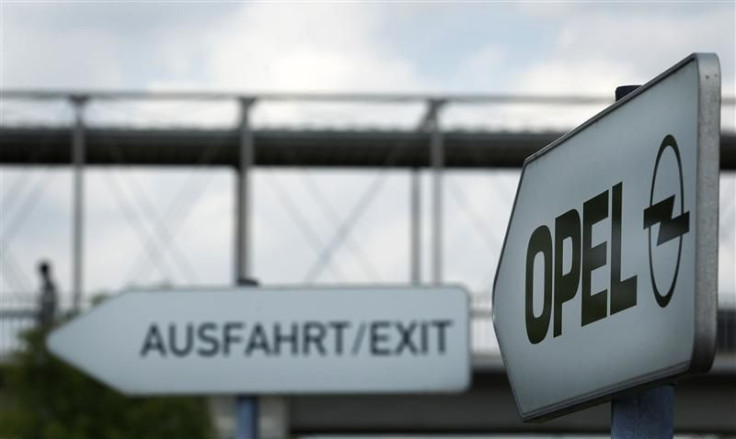 Traffic signs leading the way toward the exit of the parking facility outside the headquarters of German car manufacturer Opel in Ruesselsheim