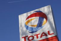 A logo for oil giant Total is seen at a petrol station in London