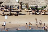 Tourists take a dip in the sea at a beach in the Red Sea resort city of Sharm el-Sheikh