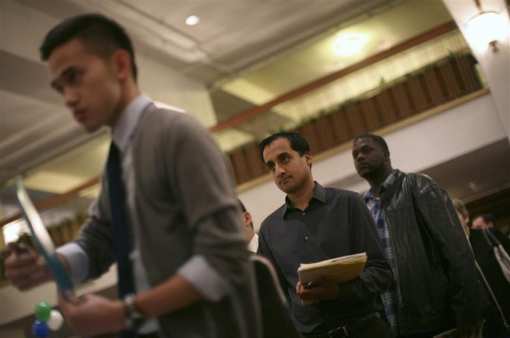 Job seekers stand in line to speak with an employer at a job fair in San Francisco