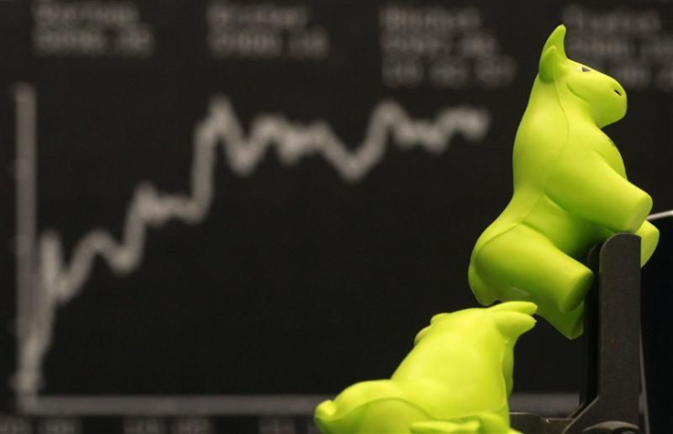 Bull figurines are pictured in front of the German DAX Index board during the first trading day at Frankfurt's stock exchange in Frankfurt