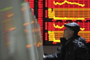 An investor checks stock information with a computer at a brokerage house in Hefei