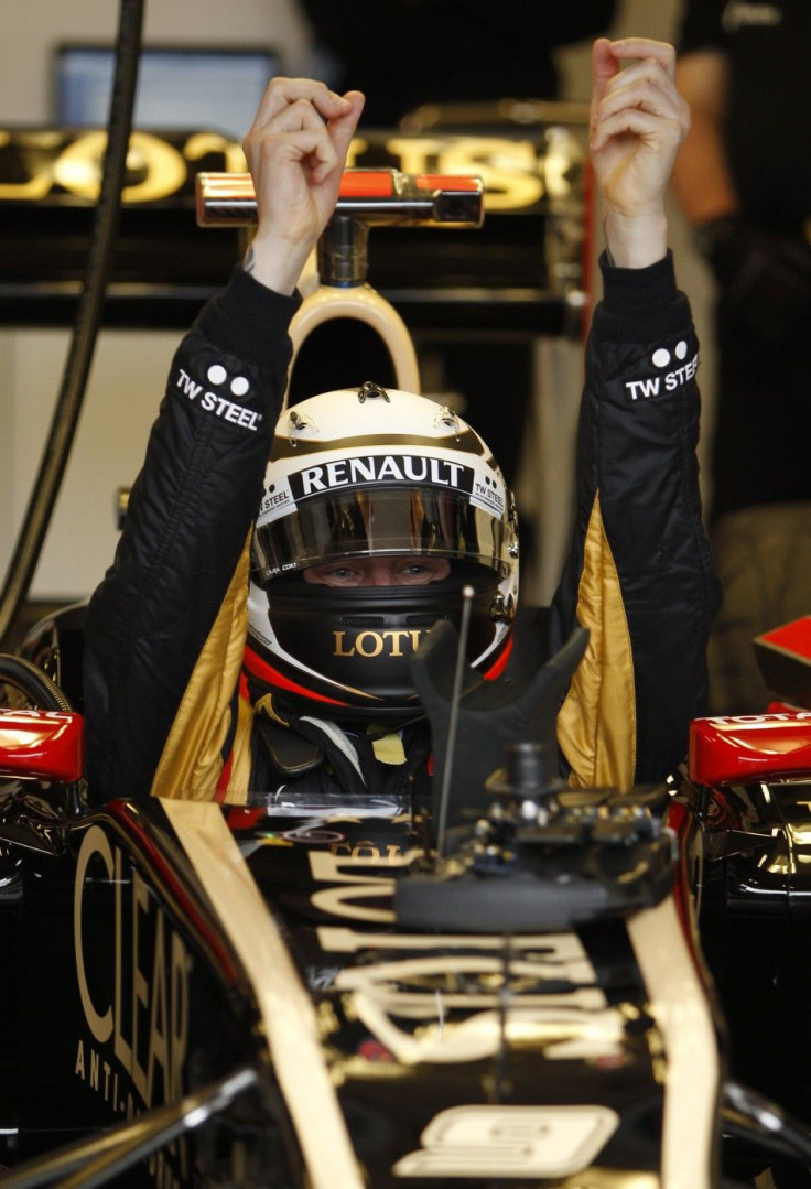 Lotus F1 Formula One driver Raikkonen gets into his car during the first practice session of the Australian F1 Grand Prix at the Albert Park circuit in Melbourne