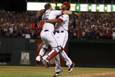 Texas Rangers relief pitcher Neftali Feliz celebrates with catcher Mike Napoli after the Rangers defeated the Detroit Tigers in Game 6 of MLB&#039;s ALCS baseball playoffs to take the pennant in Arlington