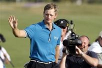 Tom Lewis of England thanks the public upon his arrival to the 18th hole during the last round of the Portugal Masters golf tournament in Vilamoura