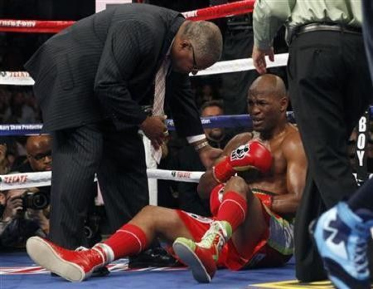 Bernard Hopkins complains of a shoulder injury to a doctor as Chad Dawson (R) wins by TKO in the second round after Hopkins fell to the canvas during their WBC Light heavyweight title bout in Los Angeles, California