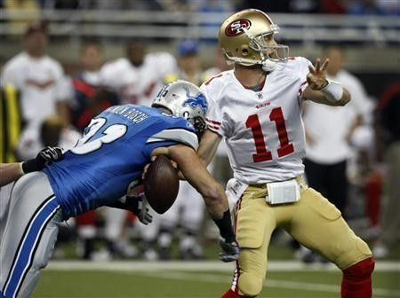 Detroit Lions defensive end Kyle Vanden Bosch strips the ball from San Francisco 49ers quarterback Alex Smith during the first half of their NFL football game in Detroit, Michigan