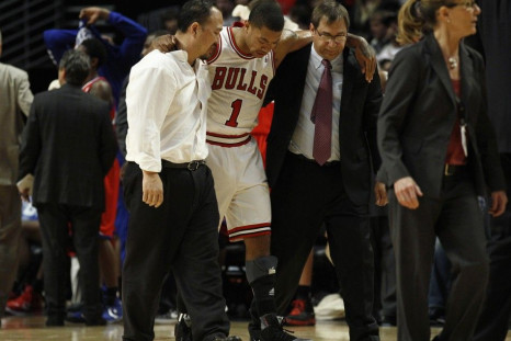 Derrick Rose is helped off the floor after tearing his ACL in his left knee.