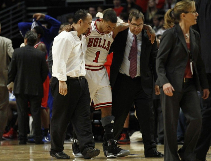 Derrick Rose is helped off the floor after tearing his ACL in his left knee.