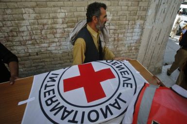Hospital staff and rescue workers carry the casket of Khalil Rasjed Dale, a British doctor working with the International Committee of the Red Cross, to an ambulance at a hospital in Quetta