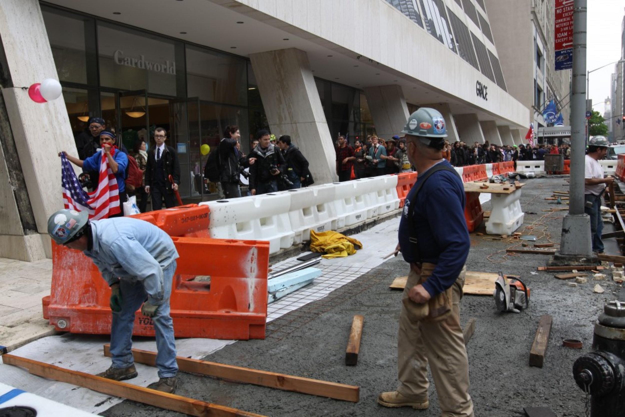 Most onlookers either ignored or offered faint praise to the demonstrators. Above, two constructions workers on East 42nd Street pause their work to observe the march go by them.