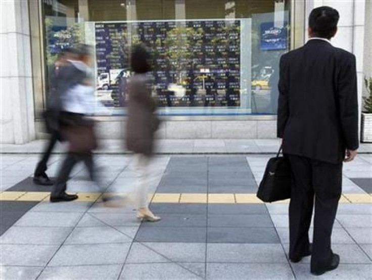 A man watches a stock index board outside a brokerage in Tokyo