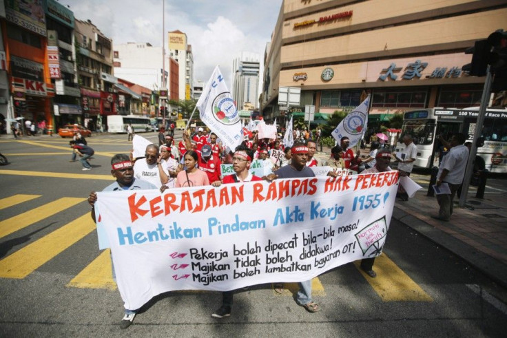 Protesters carry a banner during a May Day rally in Kuala Lumpur