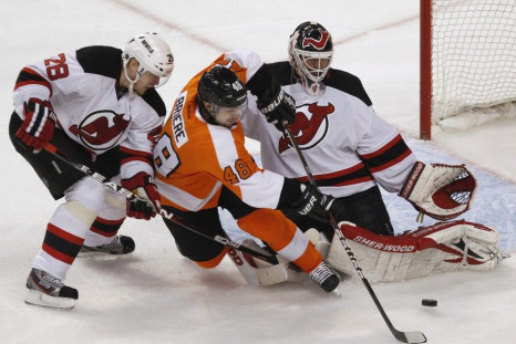 New Jersey Devils Goalie Brodeur makes a save on the Philadelphia Flyers center Briere during their NHL Eastern Conference semifinal playoff hockey series in Philadelphia