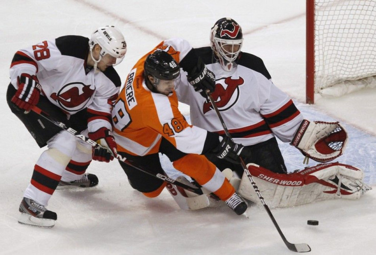 New Jersey Devils Goalie Brodeur makes a save on the Philadelphia Flyers center Briere during their NHL Eastern Conference semifinal playoff hockey series in Philadelphia