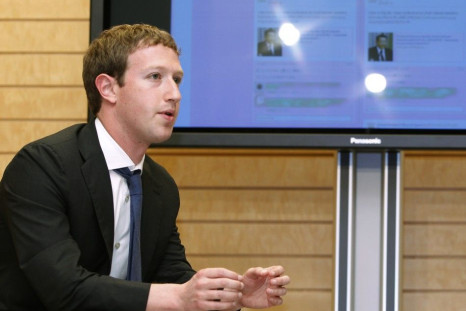 Facebook CEO Mark Zuckerberg speaks to Japanese Prime Minister Yoshihiko Noda in front of a monitor displaying a Facebook page of the Prime Minister's Office of Japan, as they meet at the latter's official residence in Tokyo on March 29, 2012.