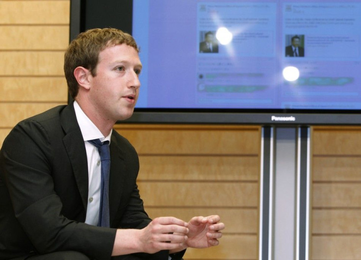Facebook CEO Mark Zuckerberg speaks to Japanese Prime Minister Yoshihiko Noda in front of a monitor displaying a Facebook page of the Prime Minister's Office of Japan, as they meet at the latter's official residence in Tokyo on March 29, 2012.