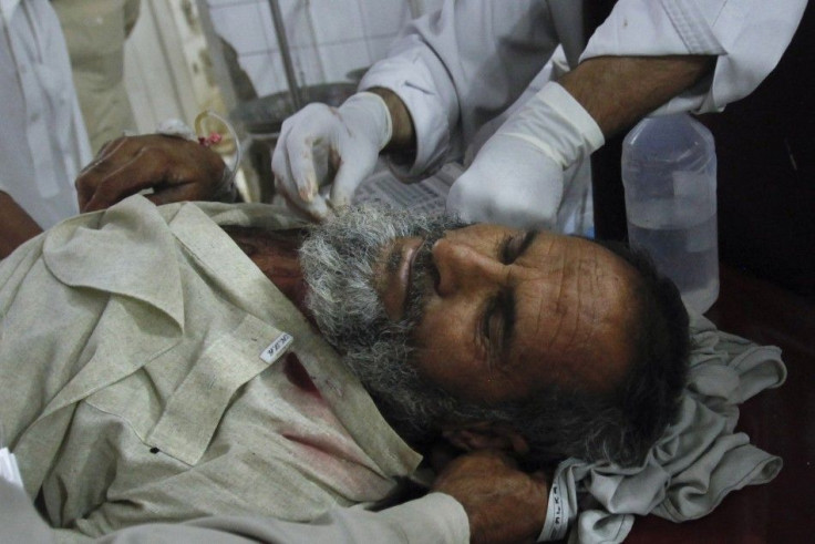 Medics attend to a man who was injured in a suicide bomb attack in northwest Bajaur region, after he was brought to Lady Reading Hospital in Peshawar for treatment