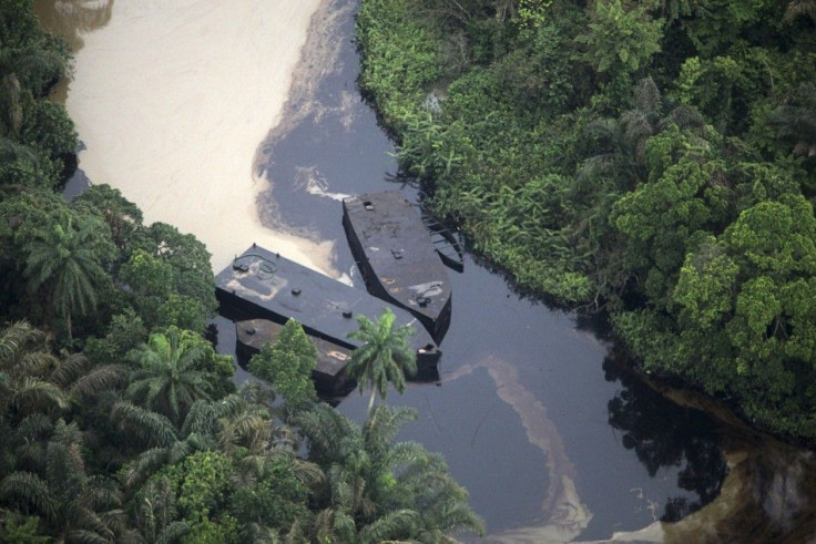 An aerial view during a media tour by oil company Shell shows locally built barges surrounded by the runoff from crude oil at an illegal oil refining site along the Imo river near Nigeria&#039;s oil hub city of Port Harcourt