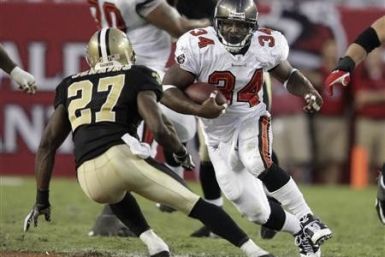 Tampa Bay Buccaneers running back Earnest Graham (34) tries to elude New Orleans Saints free safety Malcolm Jenkins (27) during their NFL football game in Tampa, Florida