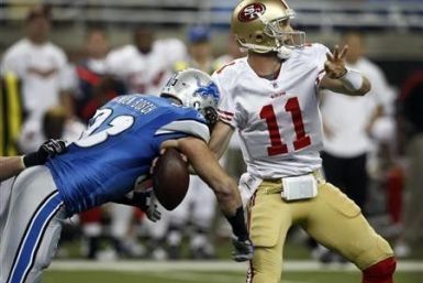 Detroit Lions defensive end Kyle Vanden Bosch strips the ball from San Francisco 49ers quarterback Alex Smith during the first half of their NFL football game in Detroit, Michigan