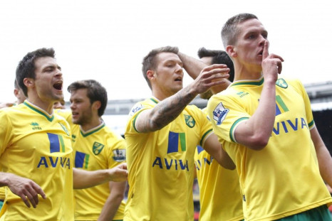 Norwich celebrates a goal by quieting Anfield.