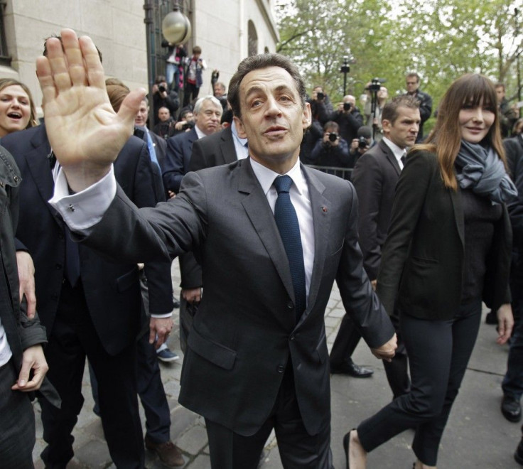 Nicolas Sarkozy, France&#039;s President and UMP party candidate for his re-election, and his wife Carla Bruni-Sarkozy leave after voting in the second round in Paris