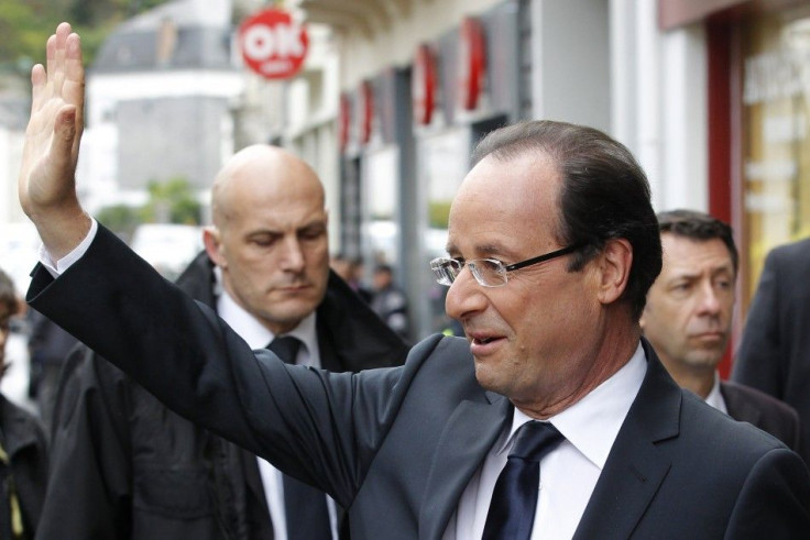 Hollande, Socialist Party candidate for the 2012 French presidential election waves as he arrives at a polling station in Tulle