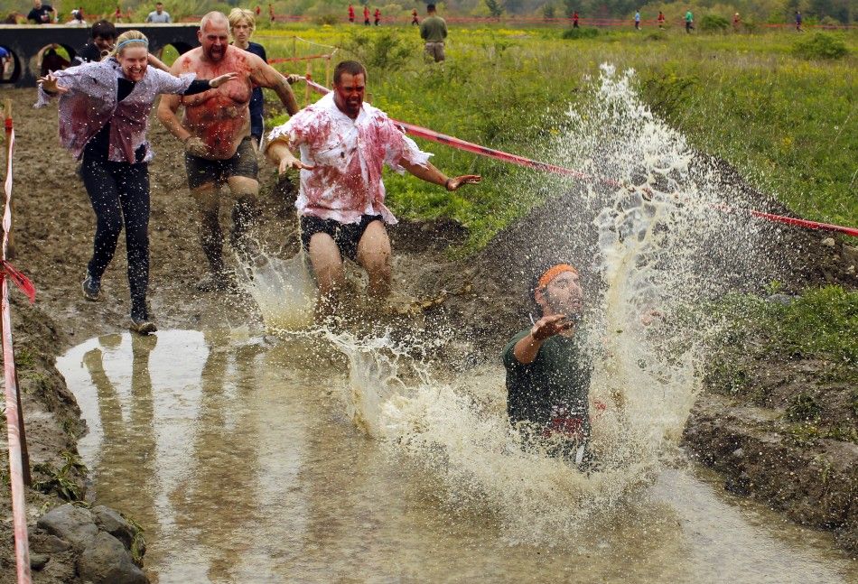 Zombies chase a runner into a pool of water on the quotRun for Your Livesquot 5K obstacle course race in Amesbury