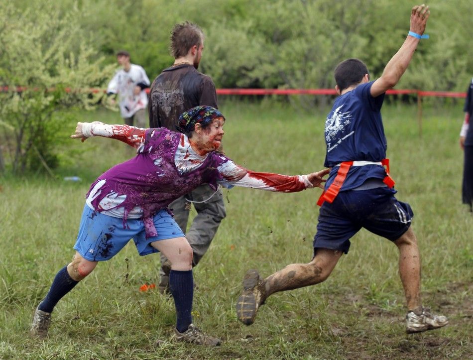 A zombie chases a runner on the quotRun for Your Livesquot 5K obstacle course race in Amesbury