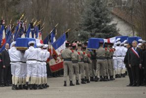 Coffins are carried by soldiers during an homage to the four slain soldiers killed last week in Afghanistan in Varces, French Alps