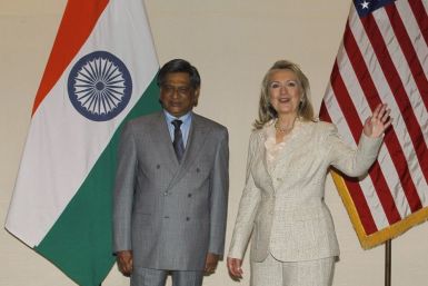 U.S. Secretary of State Clinton gestures as India's Foreign Minister Krishna watches during photo opportunity ahead of their meeting in New Delhi