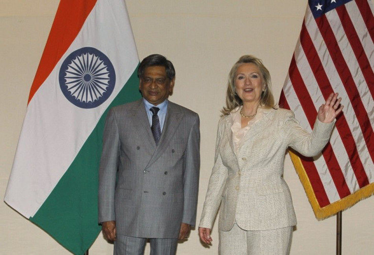 U.S. Secretary of State Clinton gestures as India's Foreign Minister Krishna watches during photo opportunity ahead of their meeting in New Delhi