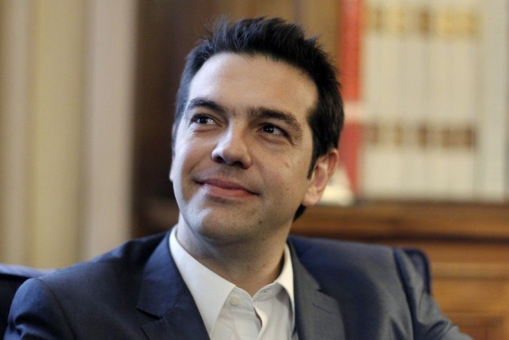 Leader of the Left Coalition party Tsipras smiles during a meeting with Greek President Papoulias in Athens