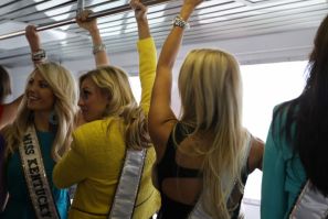 Several Miss USA contestants attempt to balance themselves while on a rocky cruise of the Hudson river