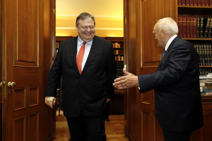 Leader of Socialist PASOK party Venizelos smiles at Greek President Papoulias before he is given a mandate to form a coalition government in Athens
