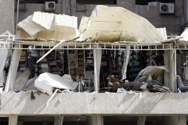 Sections of a wall is seen torn away, revealing the inside of a security building after an explosion in Damascus