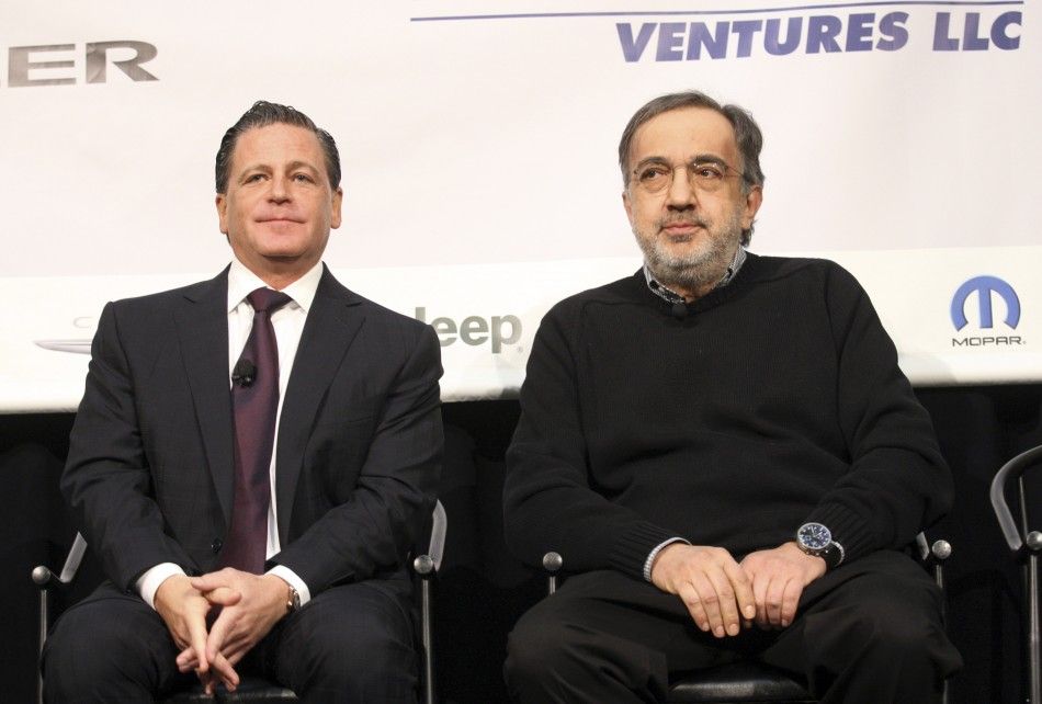 Sergio Marchionne R, chairman and CEO of Chrysler Group LLC, sits next to Dan Gilbert, chairman of Rock Ventures and Quicken Loans, during an announcement that Chrysler Group will move some of its employees into the historic Dime Building, one of Gilber
