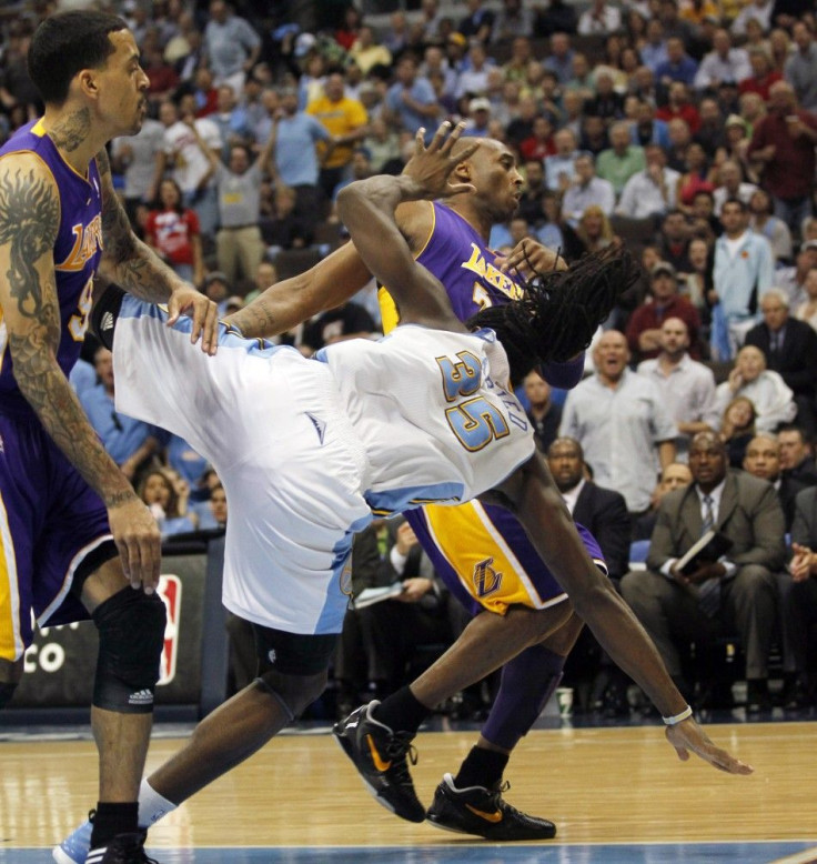 Kenneth Faried goes down after a flagrant foul from Kobe Bryant.