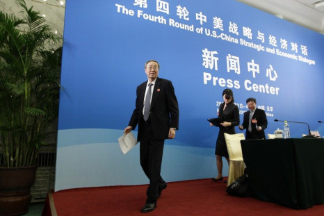 Zhou Xiaochuan, left, China's central bank governor, leaves after a news conference as a part of the U.S.-China Strategic and Economic Dialogue at the Diaoyutai State Guesthouse in Beijing, May 3, 2012.