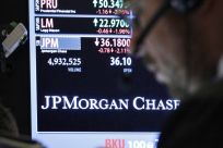 A trader enters an order by a post that sells JP Morgan Chase stock on the floor of the New York Stock Exchange