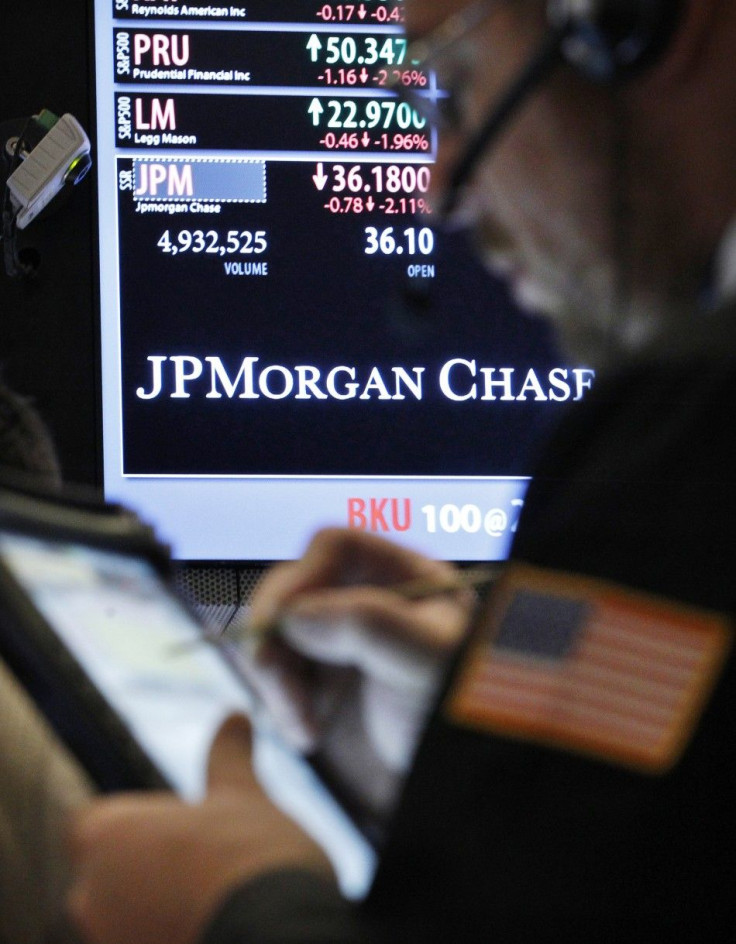 A trader enters an order by a post that sells JP Morgan Chase stock on the floor of the New York Stock Exchange