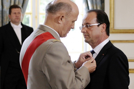France's newly-elected President Francois Hollande is awarded &quot;Grand Maitre&quot; in the Order of the Legion of Honour at the handover ceremony at the Elysee Palace in Paris, Reuters