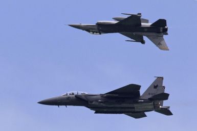 F-16C and F-15SG fighter aircraft from the RSAF perform during an aerial display at Singapore Airshow in Singapore