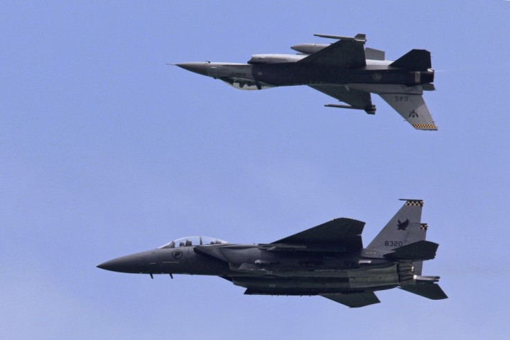 F-16C and F-15SG fighter aircraft from the RSAF perform during an aerial display at Singapore Airshow in Singapore